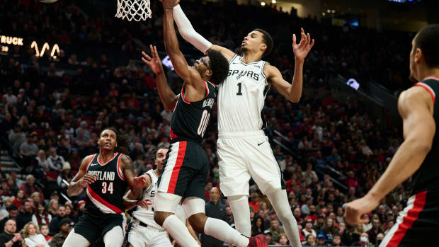 Dec 28, 2023; Portland, Oregon, USA; San Antonio Spurs center Victor Wembanyama (1) blocks a shot during the first half against Portland Trail Blazers guard Scoot Henderson (00) at Moda Center.